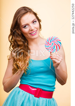 Woman joyful girl with lollipop candy 127442250
