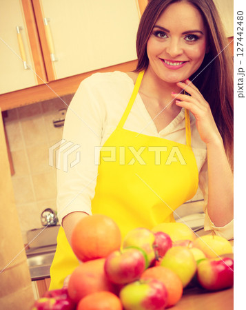 Female cook working in kitchen. 127442480