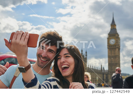 Travel, phone and couple take a selfie in London to post outdoor city street content on social media. Big ben, freedom and happy woman loves taking pictures with partner on a fun holiday adventure Travel, phone and couple take a selfie in London to post outdoor city street content on social media. Big ben, freedom and happy woman loves taking pictures with partner on a fun holiday adventure 127442549