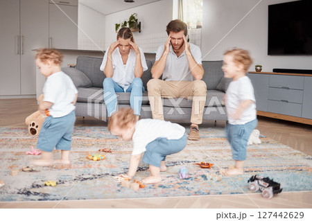 Parents, stress and busy with an adhd child running around a home living room with energy or motion blur. Family children and headache with a hyperactive kid in a lounge with a stressed mom and dad Parents, stress and busy with an adhd child running around a home living room with energy or motion blur. Family children and headache with a hyperactive kid in a lounge with a stressed mom and dad 127442629