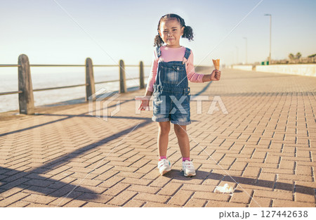Upset little girl, ice cream and sad in Cape Town with expression in frustration for a spoilt day by the ocean bay. Unhappy moody child holding empty icecream cone melting mess on floor at sea point Upset little girl, ice cream and sad in Cape Town with expression in frustration for a spoilt day by the ocean bay. Unhappy moody child holding empty icecream cone melting mess on floor at sea point 127442638