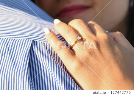 A happy fiancee showing engagement ring 127442779