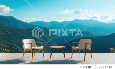 Modern chairs and table overlooking stunning mountain view, creating serene atmosphere for relaxation 127443738