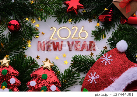 Abstract background of Christmas attributes The inscription NEW YEAR 2026. Abstract background of Christmas attributes The inscription NEW YEAR 2026. 127444391