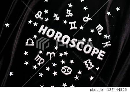 Horoscope inscription on a black velvet background. 127444396