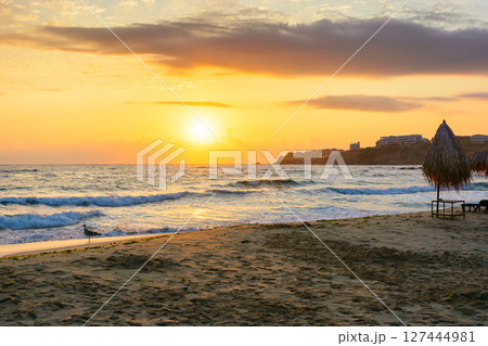 sunrise at the beach with gorgeous sky. summer getaway wallpaper on a black sea. vacation season. calm water and orange clouds. bulgaria travel background. sunny holiday seascape. sun above horizon sunrise at the beach with gorgeous sky. summer getaway wallpaper on a black sea. vacation season. calm water and orange clouds. bulgaria travel background. sunny holiday seascape. sun above horizon 127444981