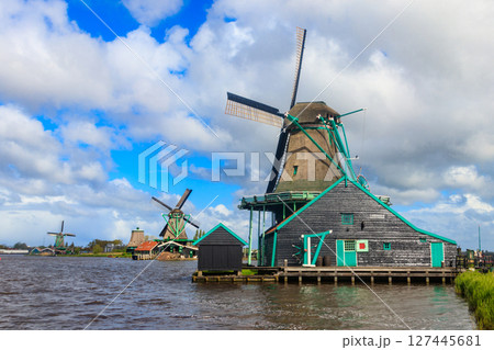 Traditional dutch windmills at the Zaan river in Zaanse Schans village, Netherlands Traditional dutch windmills at the Zaan river in Zaanse Schans village, Netherlands 127445681