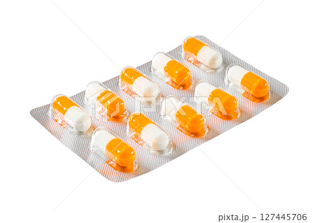 blister with medical orange and white capsules, isolated on white background with clipping path  127445706