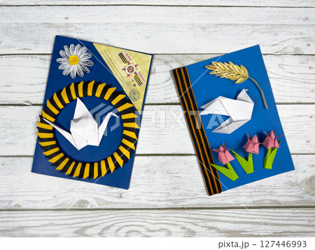 Victory Day cards with origami dove, tulips, crane, and St. George ribbon. Handmade paper crafts honoring WWII heroes and patriotic remembrance of historical victory Victory Day cards with origami dove, tulips, crane, and St. George ribbon. Handmade paper crafts honoring WWII heroes and patriotic remembrance of historical victory 127446993