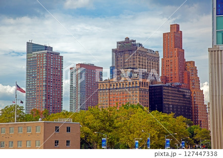 Downtown NYC architecture with trees and flag 127447338