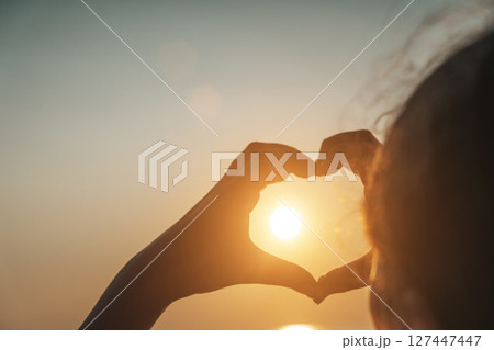 Heart Hands at Sunset Over the Sea Heart Hands at Sunset Over the Sea 127447447