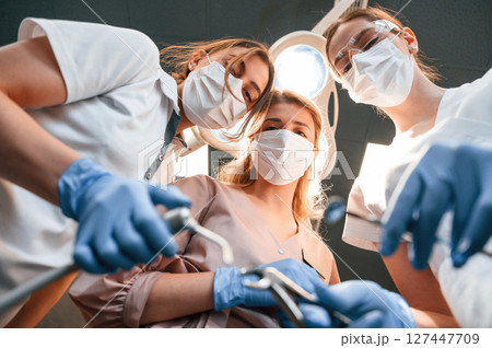 Three doctors are working. First person view. In the stomatological cabinet 127447709