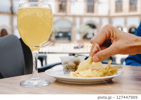 man about to eat a potato chip at an outdoor table 127447909