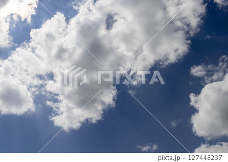 beautiful blue sky with lush white clouds in sunny bright weather beautiful blue sky with lush white clouds in sunny bright weather 127448237