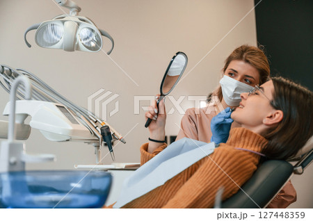 Young woman is in the chair. In the stomatological cabinet 127448359