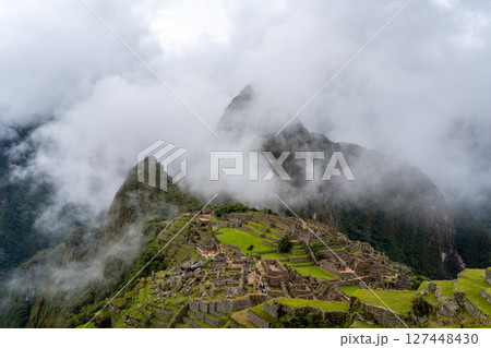 Panoramic view of Machu Picchu ruins surrounded by misty mountains, Peru Panoramic view of Machu Picchu ruins surrounded by misty mountains, Peru 127448430