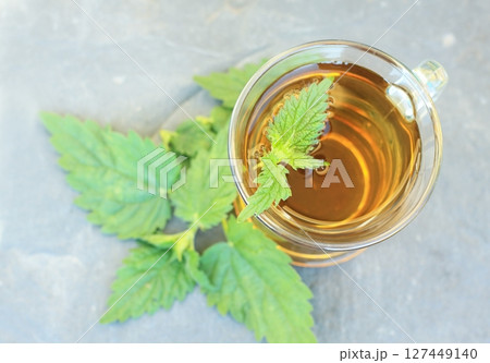 Nettle tea made from nettles Urtica dioica, flat lay. 127449140