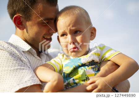 Happy dad comforts his little crying son.Paternity Happy dad comforts his little crying son.Paternity 127449890
