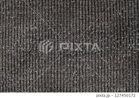 Macro texture of gray fabric with lots of pilling and damage on the surface. 127450172