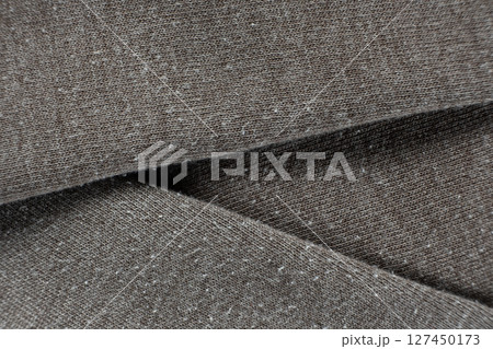 Macro texture of gray fabric with lots of pilling and damage on the surface. 127450173