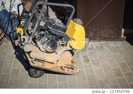 Construction equipment sits on the ground during a project at a construction site in the daytime 127450746