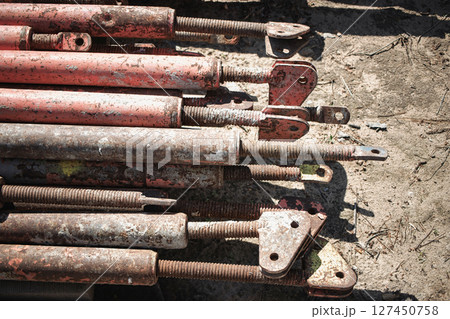 Metal scaffolding poles stacked on construction site during daylight hours 127450758