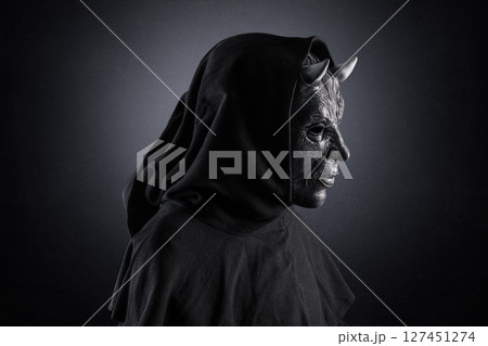 Portrait of a bad devil with horns on head over dark misty background Portrait of a bad devil with horns on head over dark misty background 127451274
