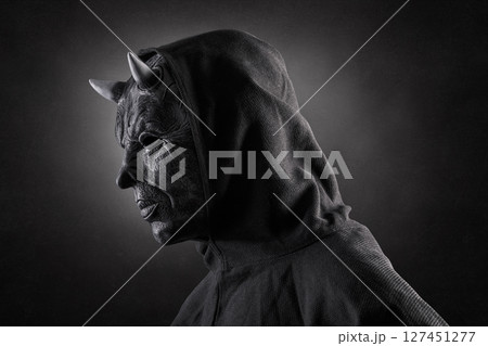 Portrait of a bad devil with horns on head over dark misty background 127451277