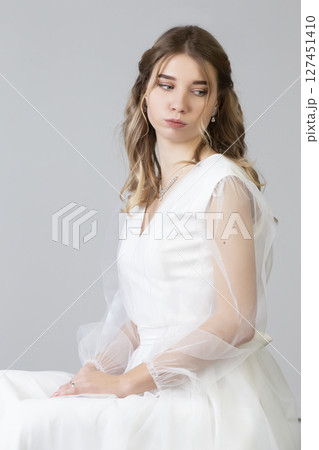 Vertical portrait of a beautiful girl bride on a white background. 127451410