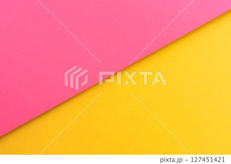 Pink and yellow paper in a flat diagonal design, aesthetic background. Pink and yellow paper in a flat diagonal design, aesthetic background. 127451421