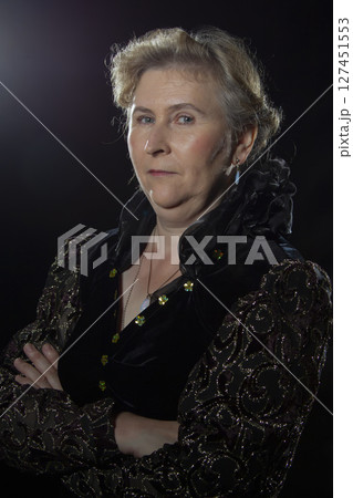 Elderly ugly woman with an evil face on a black background. Elderly ugly woman with an evil face on a black background. 127451553