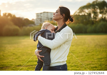 Mother is with her little baby son is on the summer field Mother is with her little baby son is on the summer field 127452644