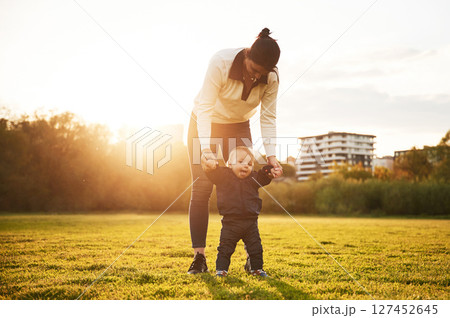 Mother is with her little baby son is on the summer field 127452645