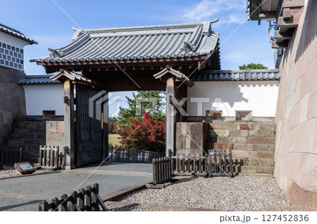 Traditional wooden gate of Kanazawa Castle in Japan with tiled roof and stone base Traditional wooden gate of Kanazawa Castle in Japan with tiled roof and stone base 127452836