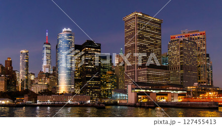 A vibrant sunset panorama of Manhattan downtown skyline, viewed from the river 127455413