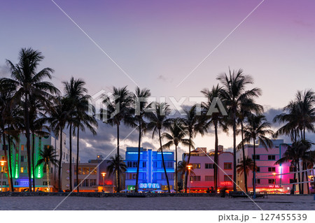 Colorful Art Deco hotels on Ocean Drive in Miami Beach glow under the warm hues of a vibrant sunset Colorful Art Deco hotels on Ocean Drive in Miami Beach glow under the warm hues of a vibrant sunset 127455539