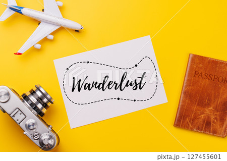 Travel-themed flat lay with blank photo card, camera, toy airplane, and passport Travel-themed flat lay with blank photo card, camera, toy airplane, and passport 127455601