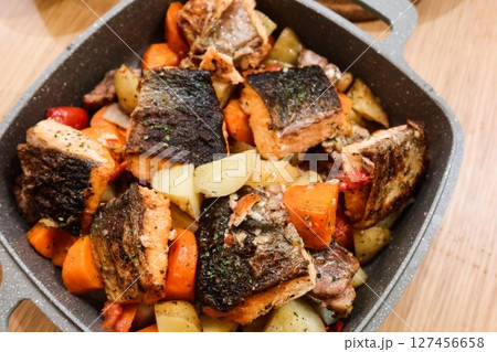 close up of homemade baked salmon carrot and potato on a big plate 127456658
