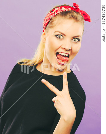 Crazy pin up retro girl making funny face. 127456739