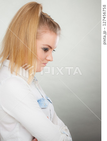 Angry woman looking very displeased standing with arms folded Angry woman looking very displeased standing with arms folded 127456758