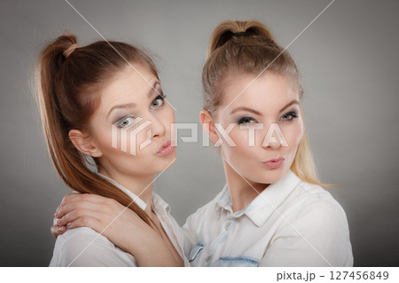 Lovely playful sisters women portrait. 127456849
