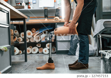Prosthesis on the floor. Technician working in modern laboratory 127457153