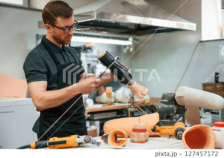 Measures the diameter of the prosthesis. Technician working in modern laboratory 127457172