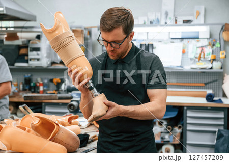 Technician working with prosthesis in modern laboratory Technician working with prosthesis in modern laboratory 127457209