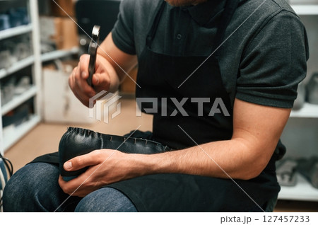 With shoe for prosthesis. Technician working in modern laboratory 127457233