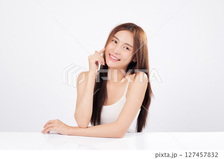Skin healthy glow and skin smooth finish make this Asian woman ideal for beauty care and skincare advertising portraying softness and confidence isolated on studio white background Skin healthy glow and skin smooth finish make this Asian woman ideal for beauty care and skincare advertising portraying softness and confidence isolated on studio white background 127457832