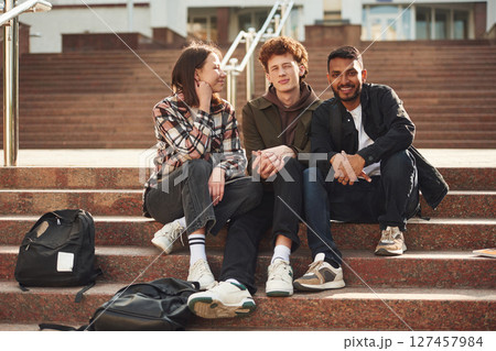 Stairs that is going up to university building. Young students in casual clothes are together outdoors 127457984