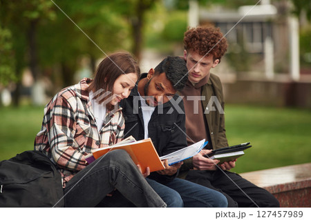 Young students in casual clothes are together outdoors 127457989