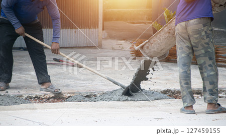 Workers are pouring cement at the construction site. Workers are pouring cement at the construction site. 127459155