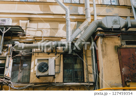 building with large air conditioner on wall. Ventilation air conditioning. cooling down in summer. building with large air conditioner on wall. Ventilation air conditioning. cooling down in summer. 127459354